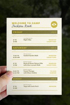 a person holding up a white and green ticket card with the words welcome to camp written on it