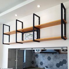 a kitchen with open shelving above the stove