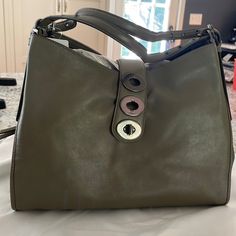 Purchased This Bag Several Years Ago And Just Haven’t Reached For It, So It’s Time For It To Have A New Home! The Color Is Called Olive Grey - More Green Than Grey In My Opinion But A Beautiful Neutral! Approximately 14 In Wide; 11 Tall; 5 Deep Includes Dust Bag Designer Hobo Bag With Detachable Strap And Round Handle, Designer Hobo Bag With Removable Pouch, Designer Hobo Bag With Double Handle For Daily Use, Designer Green Shoulder Bag With Leather Handles, Green Bag With Detachable Strap And Round Handle, Designer Hobo Bag Satchel For Office, Top Handle Bag With Magnetic Closure, Designer Shoulder Bag With Round Handle For Everyday, Designer Office Hobo Shoulder Bag