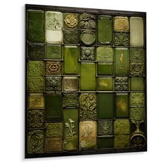 a wall with many different green tiles on it