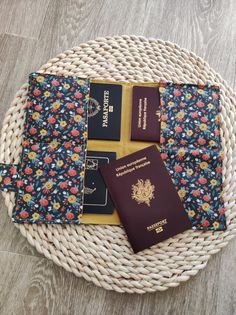 three passport covers sitting on top of a wicker basket