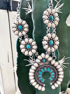 Make waves with the Selene Necklace! This statement concho necklace, adorned with beautiful turquoise stones, is sure to bring you all the compliments! With a unique style that stands out in the crowd, you'll be wearing this gorgeous piece around your neck all season long! 💎 *** EARRINGS ARE NOT INCLUDED.*** White Turquoise Bohemian Necklace, Turquoise Concho Bohemian Necklace, Turquoise Bohemian Concho Necklace, Bohemian Necklaces For Western-themed Events, Turquoise Necklace For Western-themed Events, Blue Bohemian Concho Necklace, Bohemian Blue Concho Necklace, Concho Necklace, Concho Belt