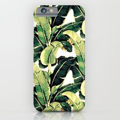 an iphone case with green leaves on it