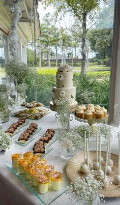 a table topped with lots of desserts and cakes