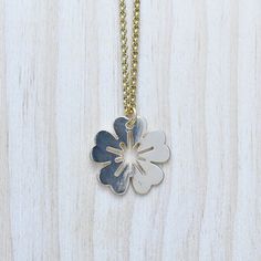 This necklace is made from a flower coin charm. The charm is gold plated and has a very shiny surface. The necklace is finished off with a gold plated stainless steel chain. You can choose the style and length of the chain. Please choose the length you would like the necklace in. Please choose the chain style you would like your pendant on. Please note that all necklaces are handmade and may differ from the pictured. The picture shows multiple necklaces. You will receive one necklace with one pe Yellow Gold Flower Charm Necklaces, Yellow Gold Flower Necklaces With Charms, Gold Nickel-free Flower Pendant Necklace, Yellow Gold Flower-shaped Necklaces With Charms, Yellow Gold Flower-shaped Necklace With Charms, Gold Flower Shaped Nickel Free Necklace, Nickel-free Gold Flower Pendant Jewelry, Gold Flower Shaped Charm Necklaces For Gifts, Gold Flower Shape Charm Necklaces As Gift