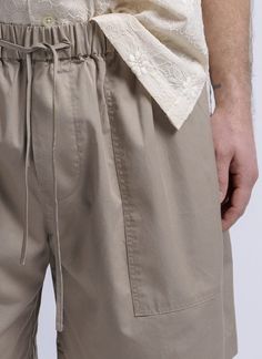 Bringing the outdoors to the city. the baggy camp short is designed with the comfort versatility and functionality of a trail short restyled with just enough fashion to become your new summer wardrobe staple. created with an elastic waistband drawstring and cut relaxed to fall at the knee. deep patch pockets at the front a back pocket with a flap side slits and a washed fine twill fabric finish for that laid back look.    made in usa    - relaxed fit  - 100% cotton  - washed fine twill fabric  - elastic waist band  - tonal draw cord  - front patch pockets  - single back patch pocket with flap  - side slits    model is wearing size m. he is 6' & 31" waist. Summer Utility Cargo Pants For Outdoor Activities, Summer Cargo Pants With Hip Pockets For Outdoor Activities, Summer Cargo Pants With Functional Pockets For Outdoor Activities, Baggy Cargo Pants For Summer Outdoor Activities, Summer Cargo Pants With Pockets For Hiking, Summer Hiking Cargo Pants With Cargo Pockets, Summer Hiking Cargo Pants With Pockets, Spring Outdoor Cargo Pants With Patch Pockets, Summer Utility Parachute Pants For Outdoor Activities