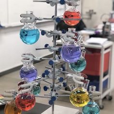 a science lab filled with lots of different colored flasks on top of each other