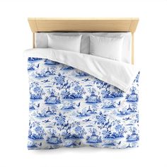 a blue and white bed with two pillows