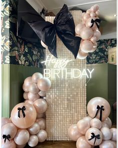 balloons and bows are on display in front of a happy birthday sign with the words happy birthday