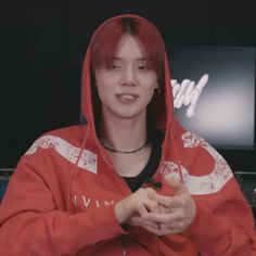 a man with red hair wearing a red hoodie