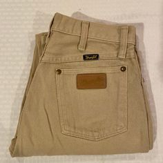 These vintage Wrangler are the classic high waisted jeans with the iconic W and Wrangler patch on the back pocket. They are in excellent condition with only one flaw on the lower left leg that can be seen in the photos.  Beautiful tan color. Tag states size 30 x 34, appx size 10, 35 x 32 is appx size 18 in women's. Please don't hesitate to ask if you need any measurements. Tan Wrangler Jeans Outfit, Vintage Mid-rise Brown Jeans, Vintage Brown Mid-rise Jeans, Vintage Straight Leg Beige Jeans, Vintage High Rise Brown Jeans, Vintage Beige Straight Leg Jeans, Vintage Beige Jeans, Vintage Brown Jeans, Tan Jeans Outfit