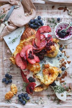 a pastry with berries, blueberries and other fruit toppings on top of it