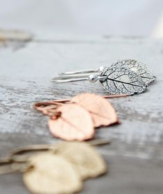 "These adorable earrings feature beautifully detailed handcrafted sterling silver leaves. The small leaf Impression Is from a natural rose leaf that was used to make a mold then cast in sterling silver. The leaves have been given an oxidized finish to accent all the details leaving them with a rustic look. Each leaf measures 12x10mm (1/2\"x3/8\") and dangles from sterling silver shepherds hook ear wire with a total drop/length of 25mm (1\"). If you have any questions please do not hesitate to co Sterling Silver Leaf Earrings With Ear Wire, Nickel-free Leaf-shaped Sterling Silver Earrings, Hypoallergenic Sterling Silver Leaf-shaped Earrings, Nickel Free Leaf-shaped Sterling Silver Earrings, Nickel Free Sterling Silver Leaf-shaped Earrings, Nickel-free Sterling Silver Leaf-shaped Earrings, Silver Leaf-shaped Earrings Gift, Sterling Silver Leaf-shaped Earrings, Silver Leaf-shaped Earrings For Gift