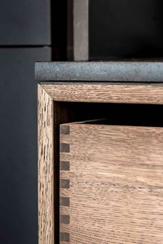 a close up of a wooden cabinet with metal handles