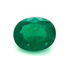 an oval cut emerald stone on a white background