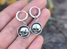 "Skull Huggie Hoops details: -.925 solid sterling silver. -12mm huggie hoop approx. 1/2\" diameter (latch back about 9mm through ear lobe), 2mm width/thickness. -Skull Measures 13mm round -Full dangle about 1.25\" -Single or Pair available More Earrings here: https://www.etsy.com/shop/AWildViolet?ref=seller-platform-mcnav&section_id=13960732 💜Check out our new \"Ready to Ship\" section for gifts that ship in 1 business day.  https://www.etsy.com/shop/AWildViolet?ref=seller-platform-mcnav§ion_id Huggie Earrings Silver, Skull Earrings, Men Earrings, Huggie Earrings, Huggie Hoop Earrings, Sterling Silver Hoops, Jewelry Earrings Hoops, Silver Hoops, Huggies Earrings