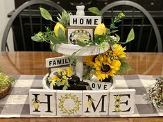 a table topped with flowers and blocks that say home, family, love, and sunflowers