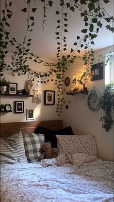 there is a bed with many plants growing on the wall and hanging from the ceiling