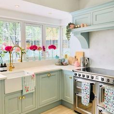 a kitchen with green cabinets and white counter tops, an oven and dishwasher