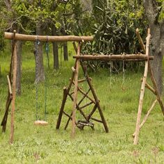 an old wooden swing set in the grass