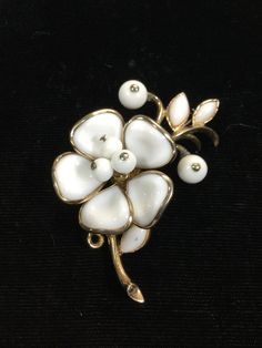 Gorgeous Trifari brooch all done on brilliant gold plated metal.  Large five molded glass petals all bezel set white milkglass with three white milkglass beaded stamen in center.  Three buff top milkglass navette leaves and two white milkglass beaded flower buds.  Measuring 2 3/8" by 1 1/4".  GORGEOUS! Trifari Brooch, Glass Molds, Dress Indian, Dress Indian Style, Flower Bud, Indian Style, Bezel Setting, Milk Glass, Brooch Pin