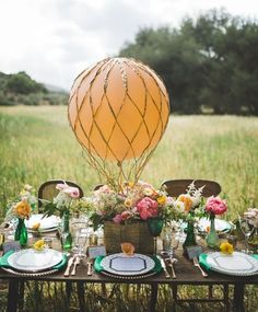 an image of a table with plates and hot air balloon