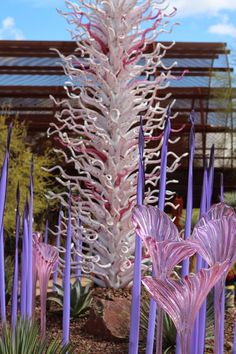 purple and white glass flowers in front of a building