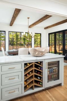 a kitchen with an island and wine cooler in it