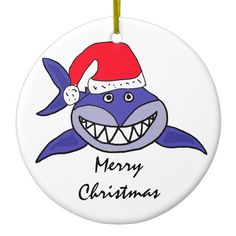 a christmas ornament with a shark wearing a santa hat