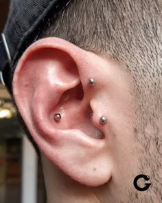 a man with two piercings on his ear