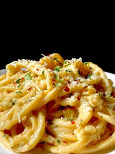 a plate full of pasta with sauce and parmesan cheese