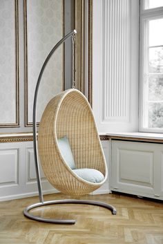 a hanging chair in the corner of a room