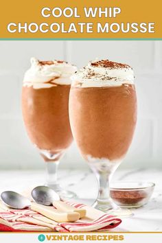 two glasses filled with chocolate mousse and topped with whipped cream