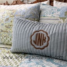 the monogrammed pillow is on top of the bed