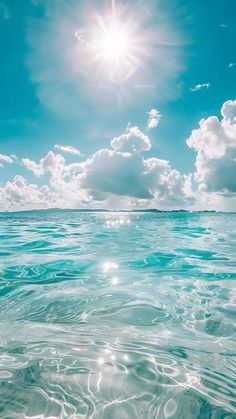 the sun shines brightly above the ocean water