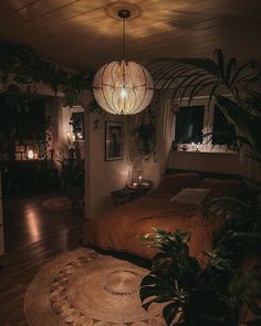 a bedroom with a bed, plants and lights