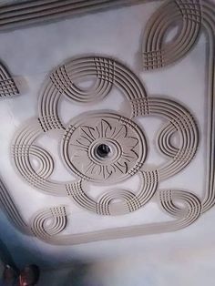 the ceiling in this room is made out of white paper and has intricate designs on it