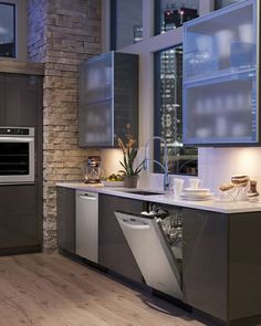 a kitchen with an oven, dishwasher and sink in it's center island