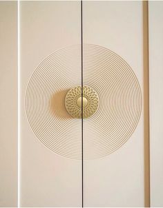 a white door with a round design on the front and side panels in gold tone