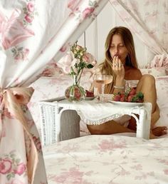 a woman is sitting on her bed and eating