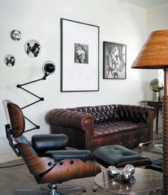 a living room with leather furniture and pictures on the wall