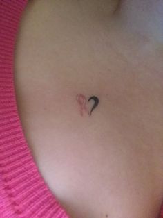 a woman's stomach with a small tattoo on the left side of her breast