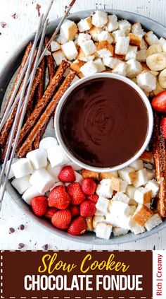 a platter filled with marshmallows, strawberries and chocolate