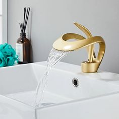 a faucet with water running from it's spout in a bathroom