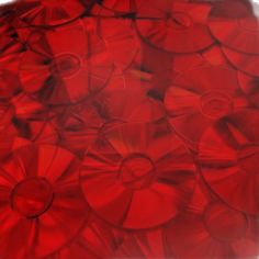 many red discs are stacked together on top of each other in an abstract pattern,