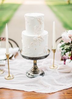 a white wedding cake sitting on top of a table