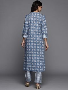 This is a beautiful 2-piece set. The set comes with straight cut kurta consist of ethnic motif print detailing has mandarin collar, 3/4th sleeves, calf length & side slits teamed with printed trouser pants has elasticated waistband and slip on closure. Piece-2 Piece Set Color-Blue Kurta Fabric-Cotton Bottom Fabric-Cotton Work - Ethnic Motif Print Detailing Neck-Mandarin Collar Sleeves- 3/4th Sleeves Kurta Length - Calf Length Bottom-Elasticated Waistband & Slip-on Closure Style-Kurta Trouser Set Spring Block Print Straight Kurta Set, Navratri Sets With Printed Border And Straight Kurta, Festive Kurta With Printed Motifs And 3/4 Sleeves, Festive Kurta With 3/4 Sleeves And Printed Motifs, Festive 3/4 Sleeve Kurta With Printed Motifs, Transitional Cotton Palazzo Set With Long Sleeves, Festive Cotton Kurta With 3/4 Sleeve, Straight Kurta With Printed Motifs For Transitional Season, Transitional Straight Kurta With Printed Motifs