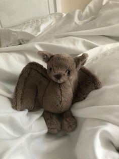 a stuffed animal sitting on top of a bed