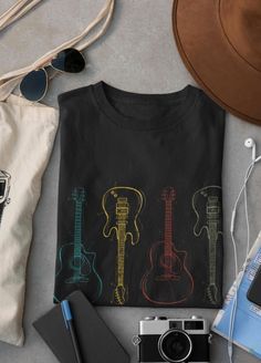 Cool retro guitar tee that is the perfect shirt for musicians, guitar players, guitar teachers and anyone who loves music. FREE SHIPPING WITHIN THE USA This classic unisex jersey short sleeve tee fits like a well-loved favorite. Soft cotton and quality print make users fall in love with it over and over again. These t-shirts have-ribbed knit collars to bolster shaping. The shoulders have taping for better fit over time. Dual side seams hold the garment's shape for longer.  .: 100% Airlume combed and ringspun cotton (fiber content may vary for different colors) .: Light fabric (4.2 oz/yd² (142 g/m .: Retail fit .: Tear away label .: Runs true to size Retro Guitar, Guitar Logo, Guitar Shirt, Cute Mask, Guitar Players, Musician Gifts, Retro Music, Cricut Ideas, Logo Tees