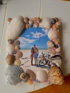 two people standing next to each other with seashells around them